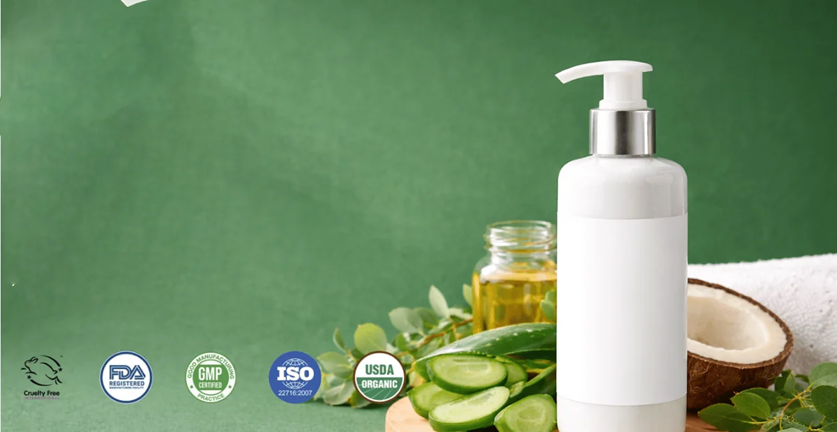 White pump bottle surrounded by natural ingredients like cucumber slices and coconut, with certification icons for organic and cruelty-free products.